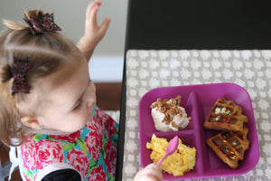 Girl eating breakfast on Kiddiebites Plum Silicone Plate